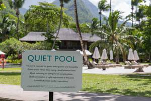 Quiet Pool Sign asks visitors for calmness and appropriate behavior at hotel resort in Mahé, Seychelles