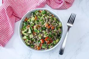 Quinoa Salad with Cucmber, Tomato and Edamame in a White Bowl