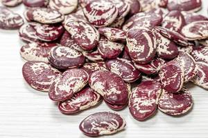 Raw big beans on a white wooden background (Flip 2019)