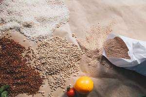 Raw cereals, buckwheat, barley, rice on paper background