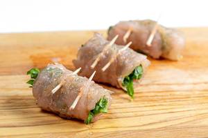 Raw chicken rolls with spinach