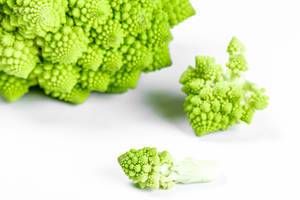 Raw fresh Romanesco broccoli on white background