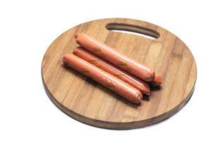 Raw hot dog Frankfurters on the wooden board