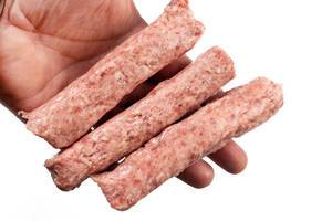 Raw Kebabs made of Minced Meat in the hand