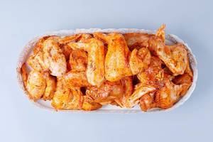 Raw spicy chicken wings in a pan, white background (Flip 2019)