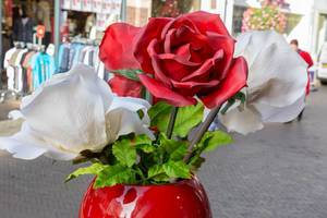 Red and white plastic roses in a vase