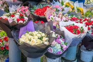 Red and White Roses Bunch in Buckets sold at a Street Vendor in Vietnam