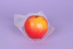 Red apple packed in bubble wrap