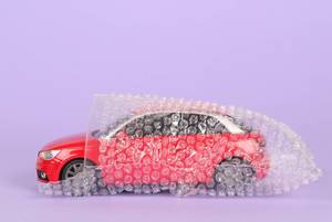 Red car packed in bubble wrap