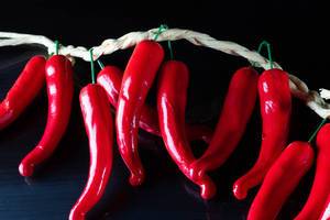 Red chilli peppers on black background (Flip 2019)