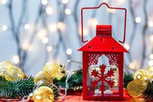 Red Christmas lantern with glowing garlands