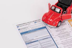 Red classic car on accident statement report