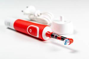 Red electric toothbrush with charger