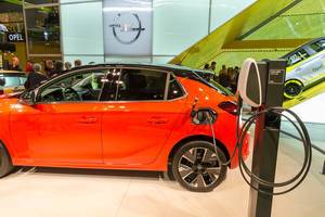 Red electric vehicle by Opel: Corsa-e The charges with universal cable at a Wall Box charging station