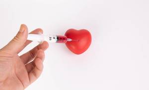 Red heart with syringe
