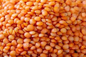 Red lentils close up. Background with a lot of lentils.