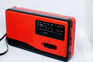 Red mini radio on white background