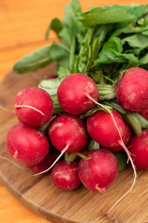 Red Radishes with wooden boards background