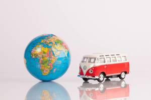 Red vintage camper van with globe