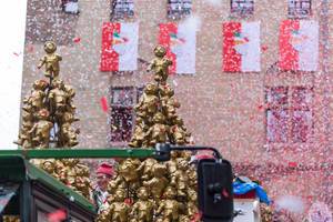 Red-white confetti fill the air at Severinstorburg at the passing of the float of Holger Kirsch, leader of the Rose Monday parade in Cologne. The float is decorated by golden "Heinzelmännchen", creatures that are a symbol of Cologne