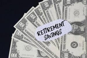 Retirement Savings text and dollar banknotes