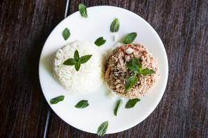Rice and meat garnished with fresh herbs