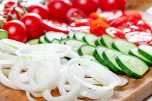 Rings of sliced onions, tomato and cucumber circles close-up (Flip 2019)