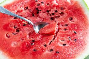 Ripe cut watermelon with seeds and spoon (Flip 2019)