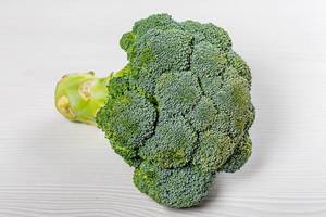 Ripe green broccoli on a white wooden background (Flip 2019)