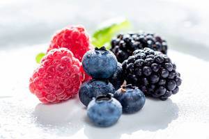 Ripe raspberries, blueberries and mulberries