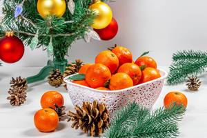 Ripe tangerines with cones and tree branches under a decorated Christmas tree (Flip 2019)