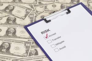 Risk accpeted concept with clipboard and dollar banknotes