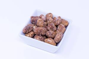 Roasted sugar coated Almonds in square bowl on white background