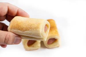 Roll buns with Hot Dog in the hand