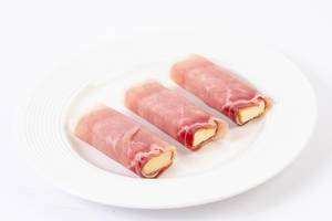 Rolled Pork Ham with yellow Cheddar cheese on the plate (Flip 2019)
