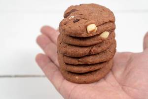 Round Chocolate Cookies on the hand above the table (Flip 2020)