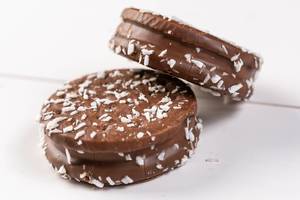 Round Chocolate Sandwich Biscuits on the white table (Flip 2019)