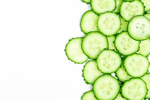Round cucumber slices on a white background with free space (Flip 2020)