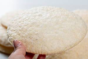 Round diet rice bread in a woman