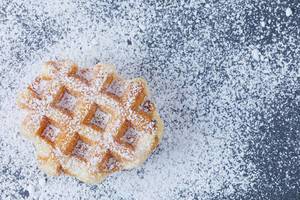 Round waffle with powdered sugar