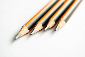Row of black and orange pencils