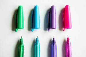 Row of color pens with their caps on top