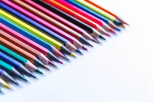 Row of colored pencils on a white background. Detail multicolored pen in line. (Flip 2019)