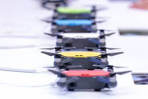 Row of DJI Spark drones of different colors