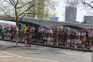 Runners running side by side and holding rope in hands - London Marathon 2018