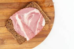 Rye Bread slice with Smoked Pork Neck on the wooden board (Flip 2019)