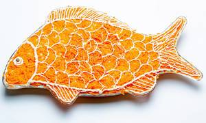 Salad layers in the shape of a fish on a white background
