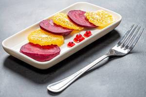 Salad with beets and oranges and berry sauce with red currants. Light lunch, healthy food concept (Flip 2019)
