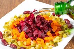 Salad with boiled beets, carrots, beans and pickles refueled with oil (Flip 2019)