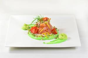 Salmon with radish sprouts, tomatoes and avocado paste